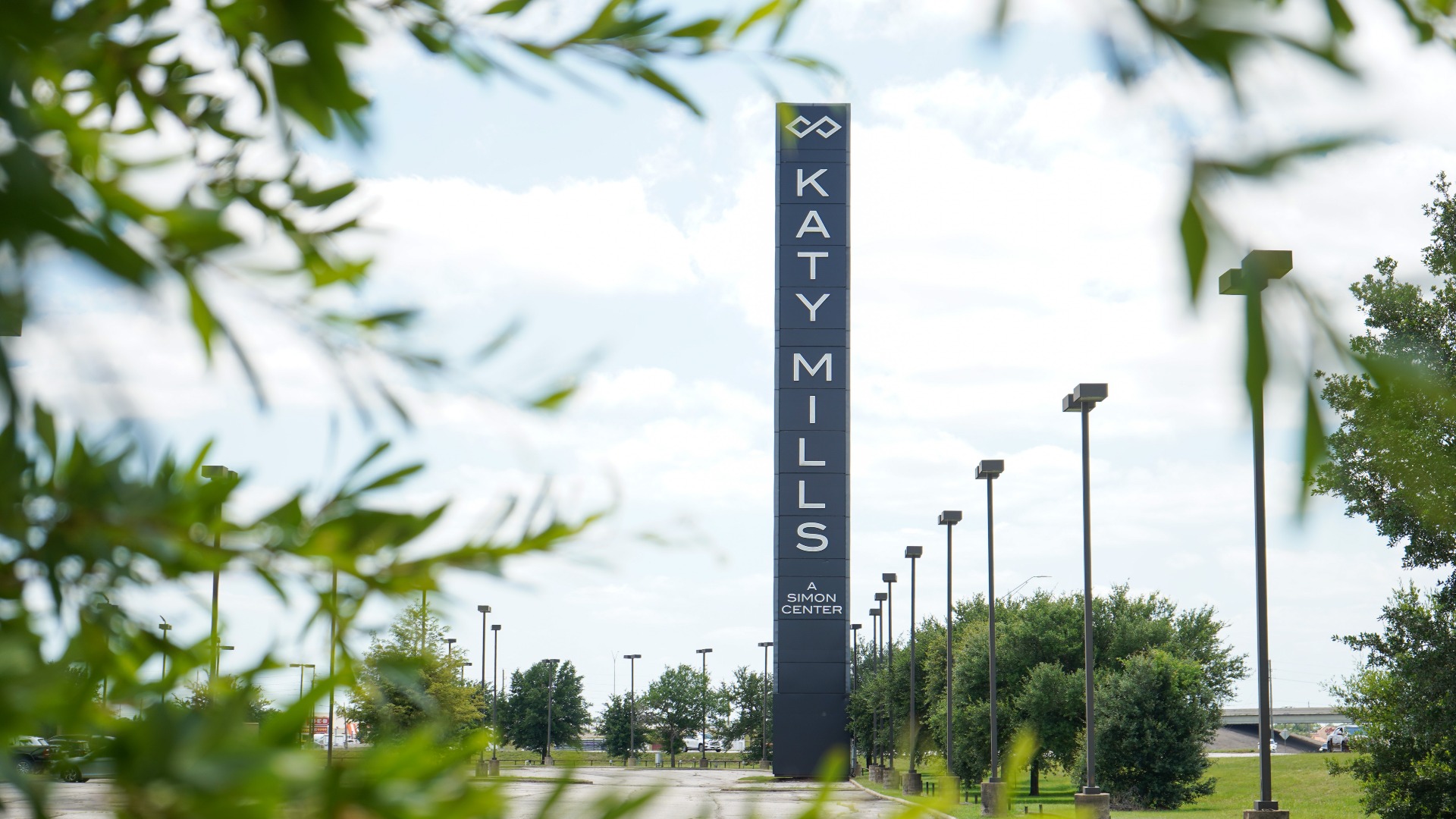 Photo of Katy Mills Mall tower with trees in foreground 