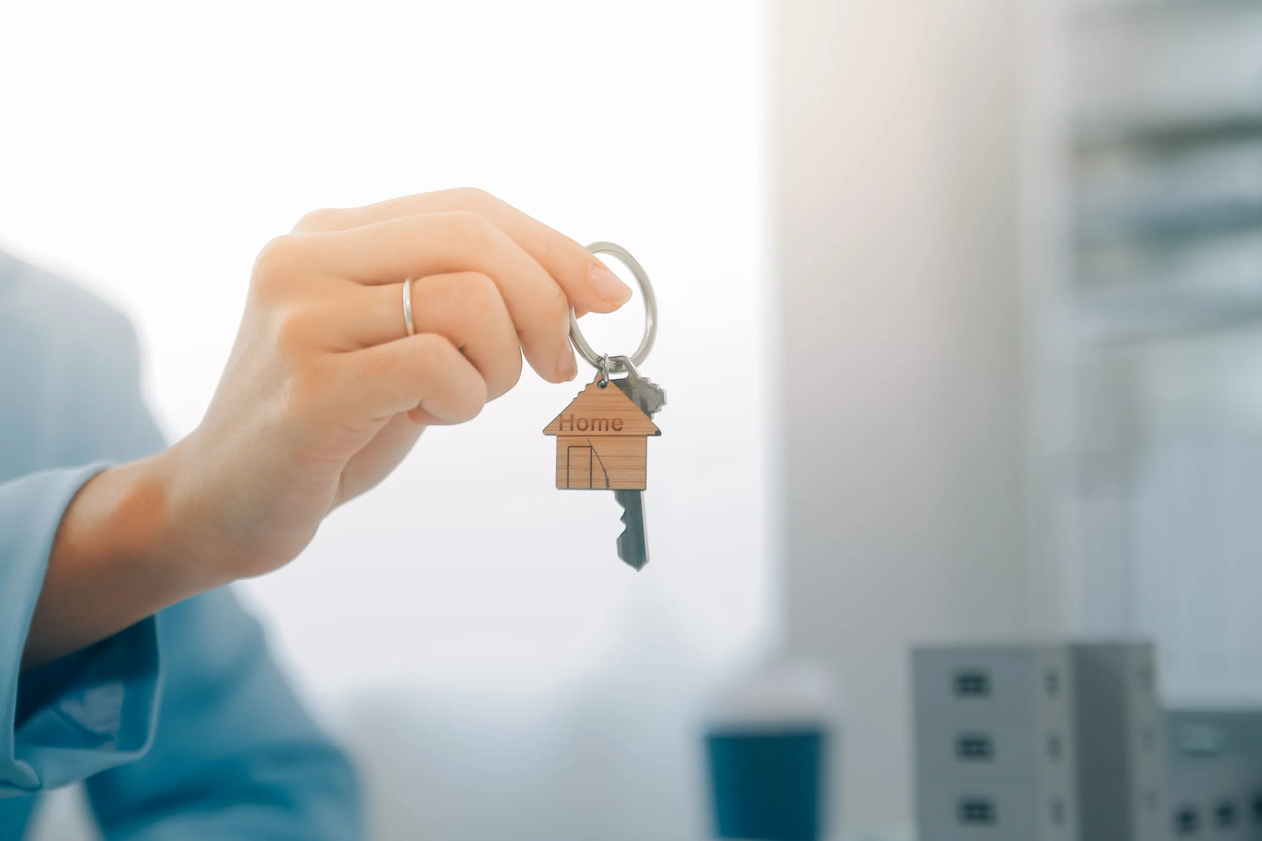 Sales professional offering keys to homeowner