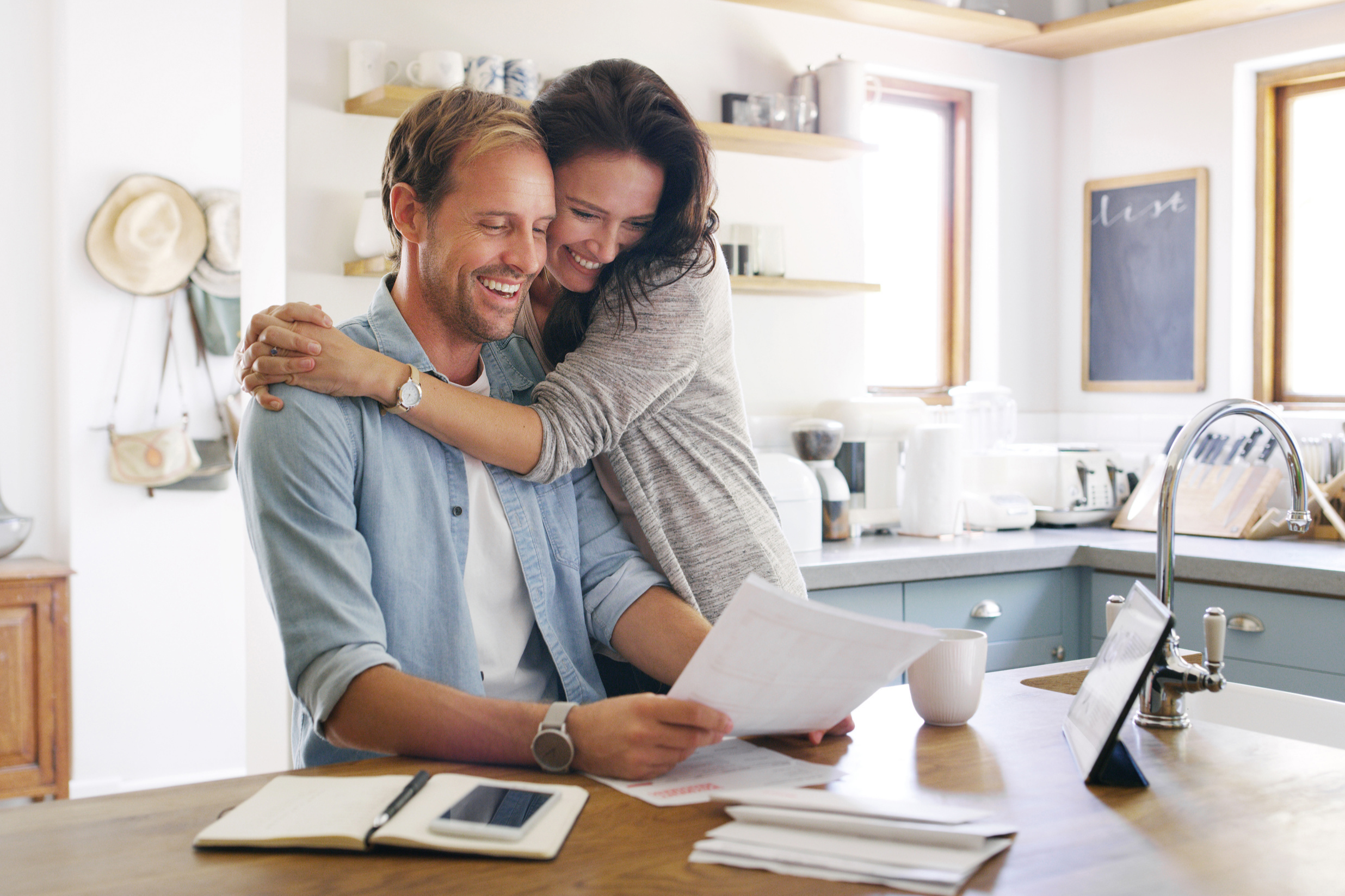 happy couple at home looking at papers